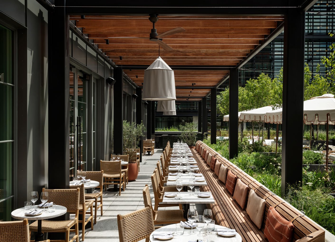 The covered terrace at Elektra, set for dinner alongside the garden