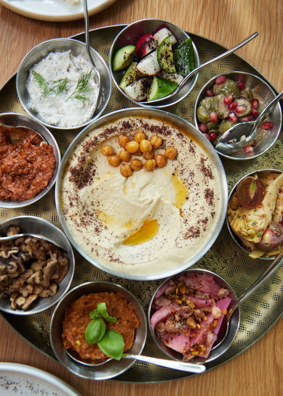A brass tray of mezze at Elektra: hummus, dips, salads and pickles